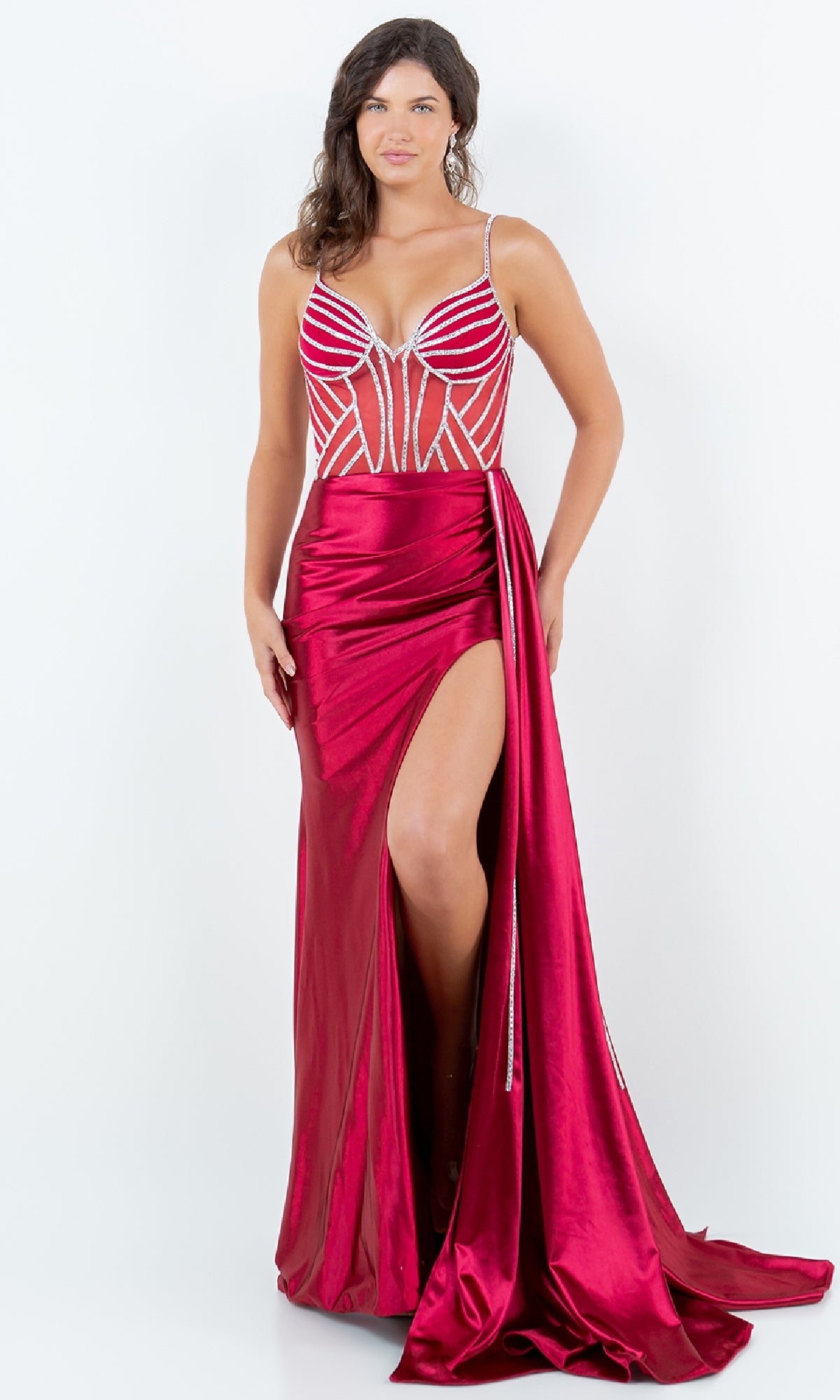 A woman models the Cinderella Couture 8219J Side-Sash Long Prom Gown, featuring red beaded details, spaghetti straps, and a high slit, against a plain white background.